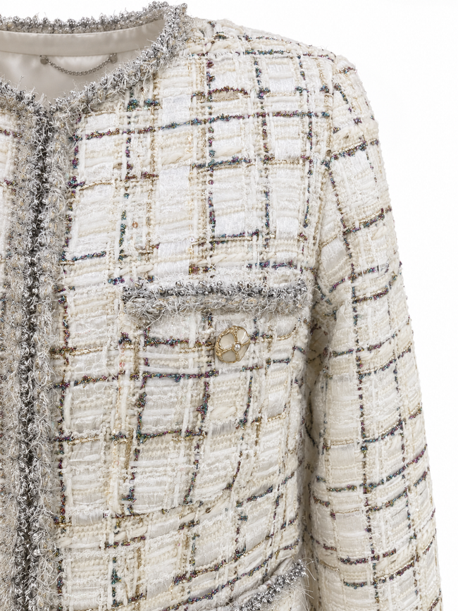 Close-up of ivory checked tweed and silver-grey fringe neckline
