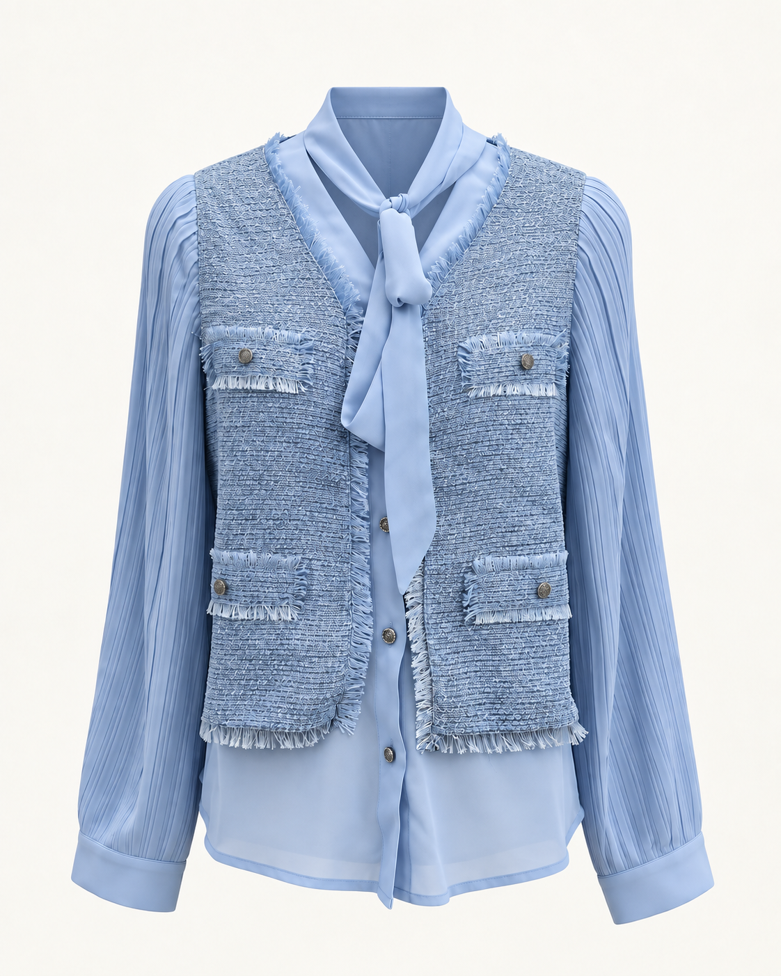 Light blue textured tie-neck top with fringed pocket details and pleated sleeves — studio front view