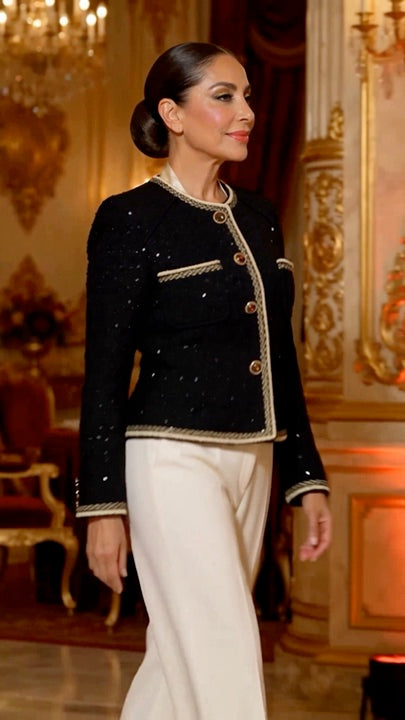 Campaign model in the black jacket and ivory trousers at a formal reception